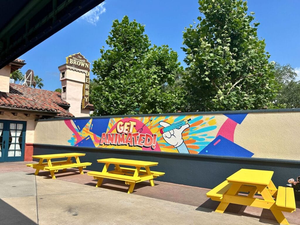 Get Animated painted wall and yellow picnic tables for Cool Kid Summer at Disney's Hollywood Studios - image by Dani Meyering