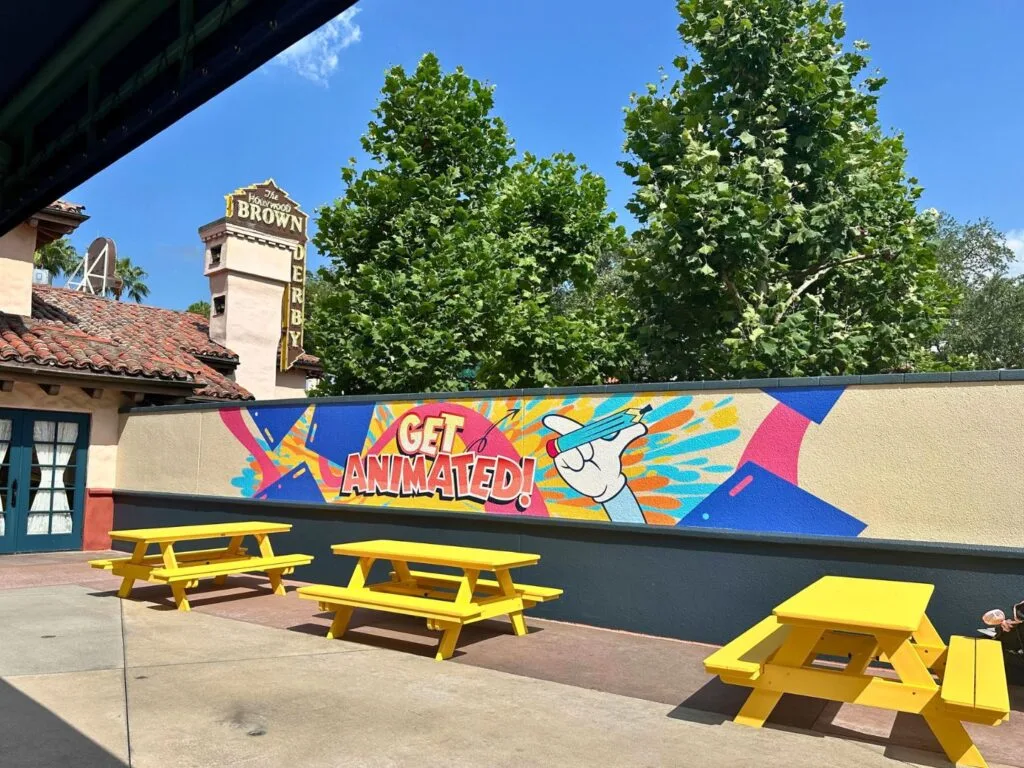 Get Animated painted wall and yellow picnic tables for Cool Kid Summer at Disney's Hollywood Studios - image by Dani Meyering