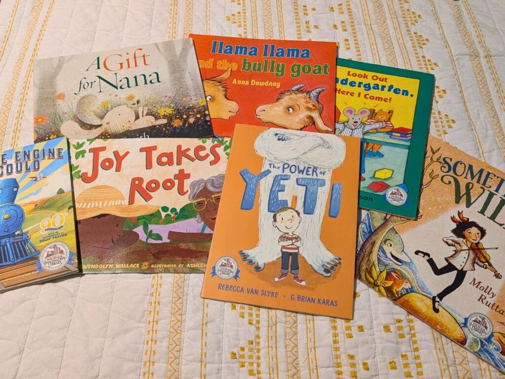 Imagination Library Books collection on bed - image by Maria DiCicco