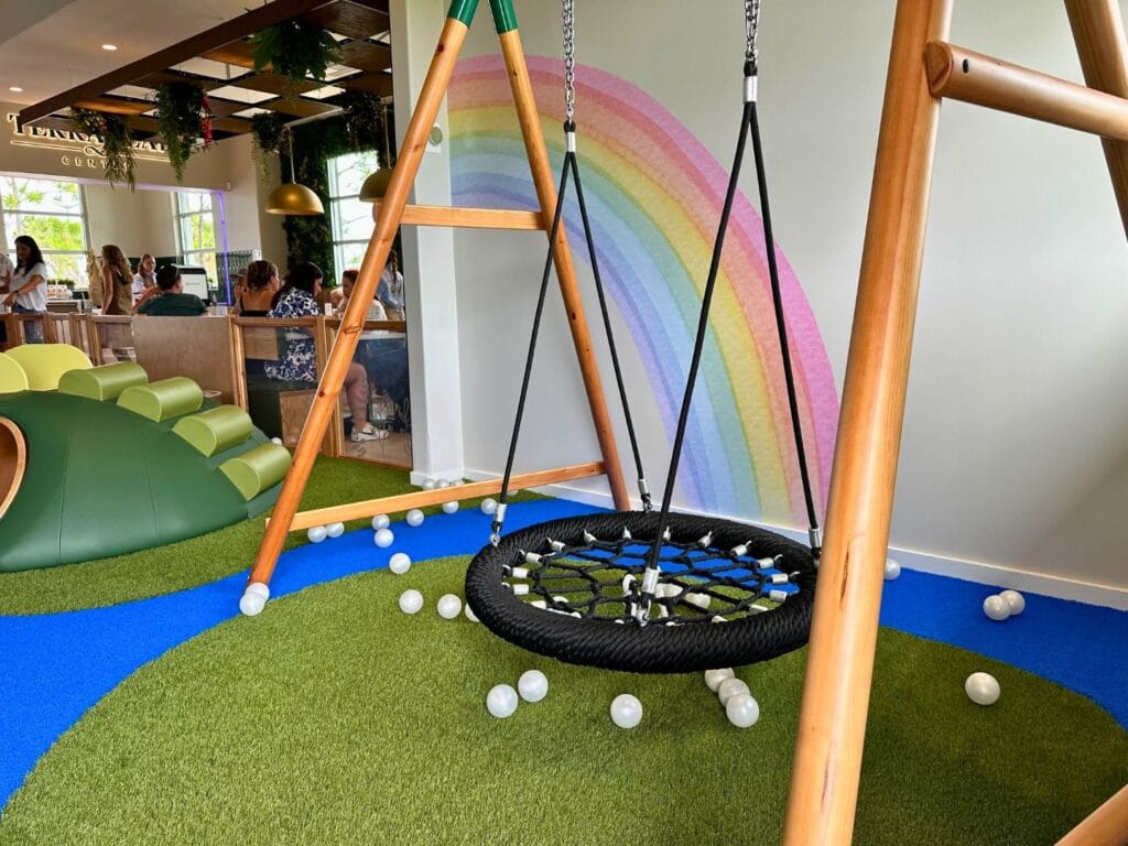 Sensory swing in play area facing cafe at Terra Play Center Lake Nona - image by Dani Meyering