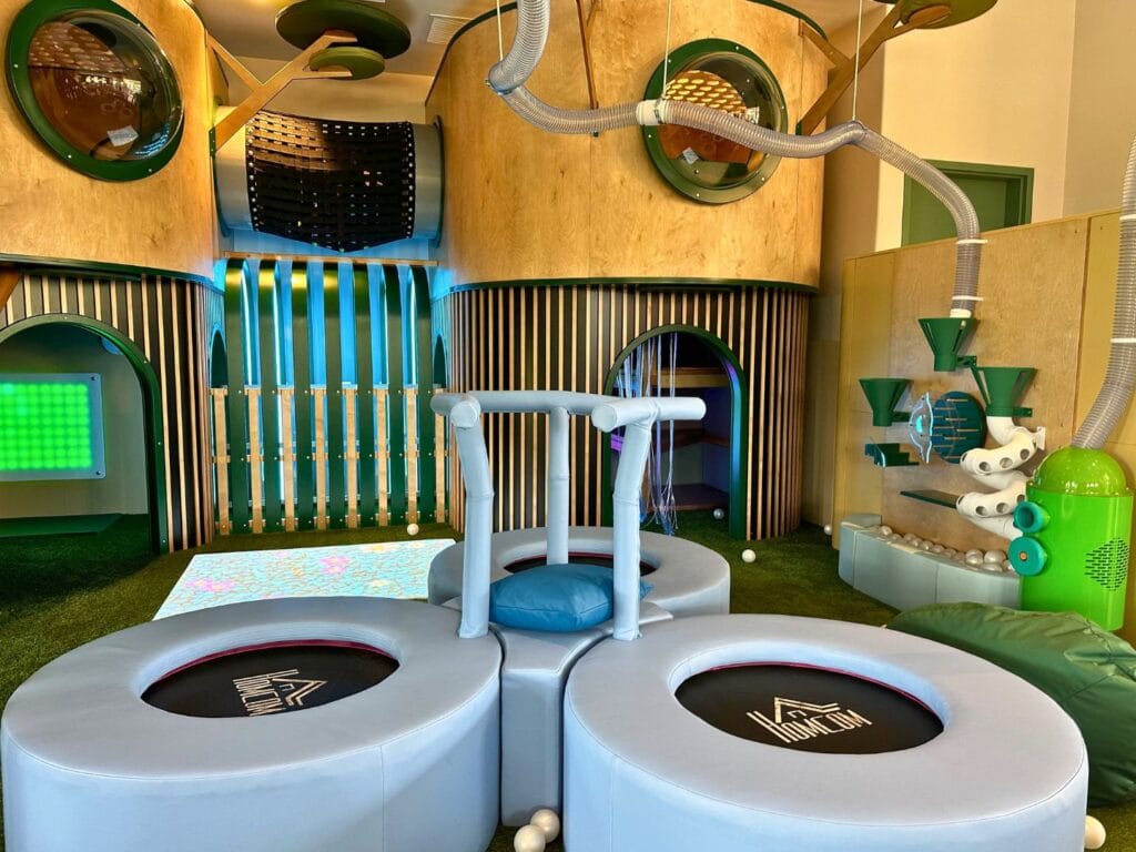 Small rebounders and balls with vacuum tube in play area at Terra Play Center Lake Nona - image by Dani Meyering