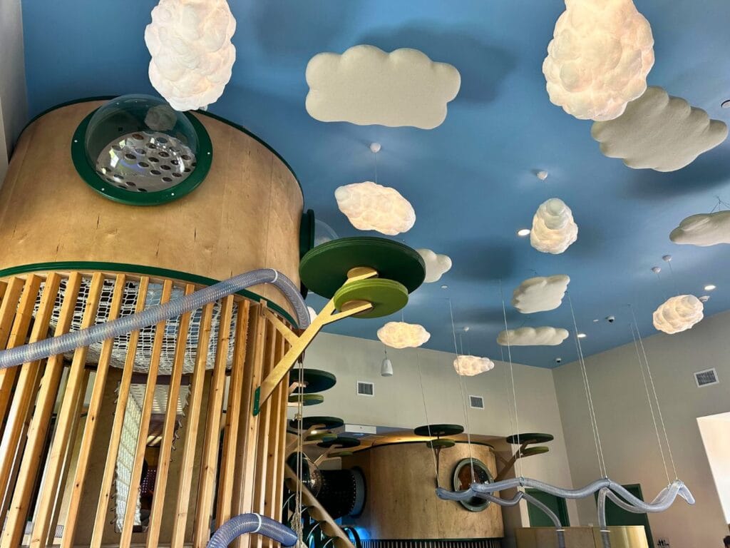 Tree house and balls with vacuum tube in play area at Terra Play Center Lake Nona - image by Dani Meyering