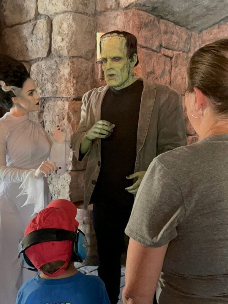 young boy and mom meet the Bride and Frankenstein's Monster at Dark Universe - image from Dani Meyering