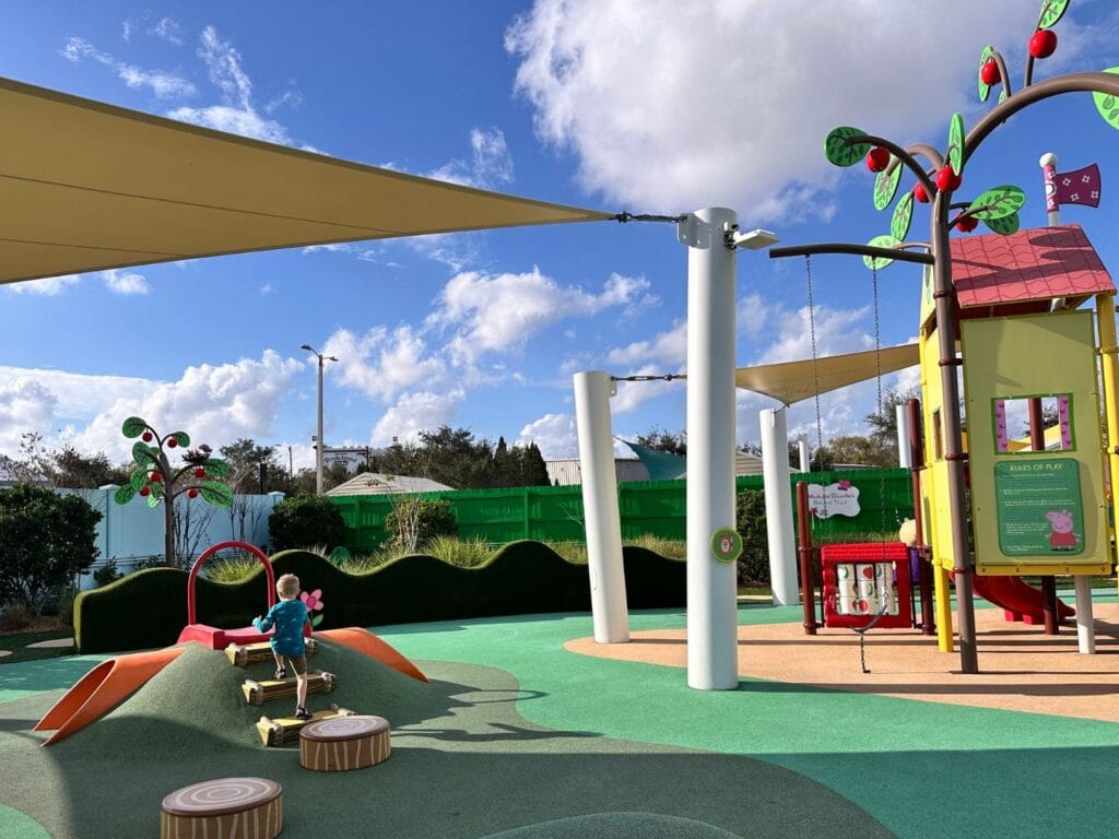 young boy playing on playground at Peppa Pig Theme Park affordable theme park index - image by Dani Meyering
