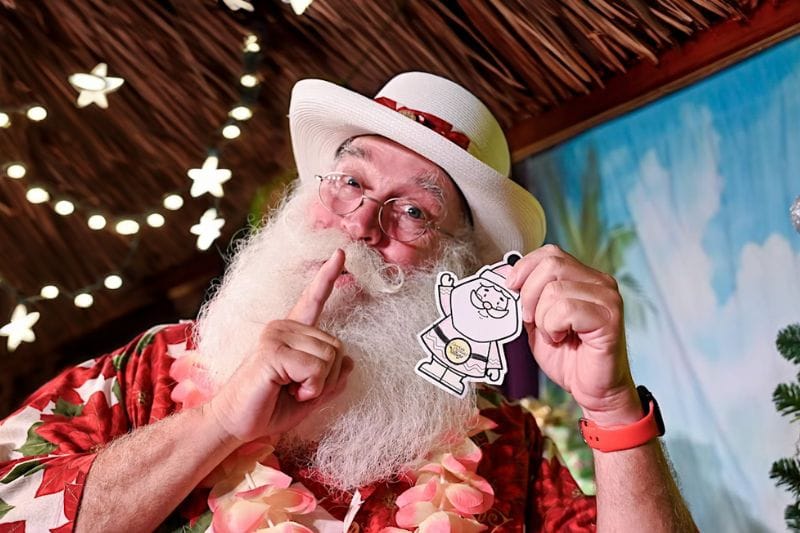 Christmas in July in Orlando tropical santa at give kids the world holding an ornament with lights - Dani edits