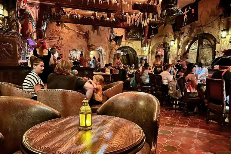 Kids with Parents sitting at The Mess Beak and Barrel Magic Kingdom - image by Dani Meyering