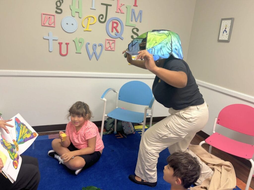 Reading programs for kids in Orlando UCF iRead Hungry Caterpillar with teacher acting out the butterfly - image provided by University of Central Florida