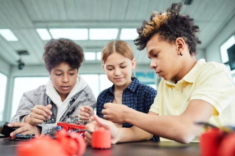 finding an after school program in orlando three kids working on a robotics project - Dani canva