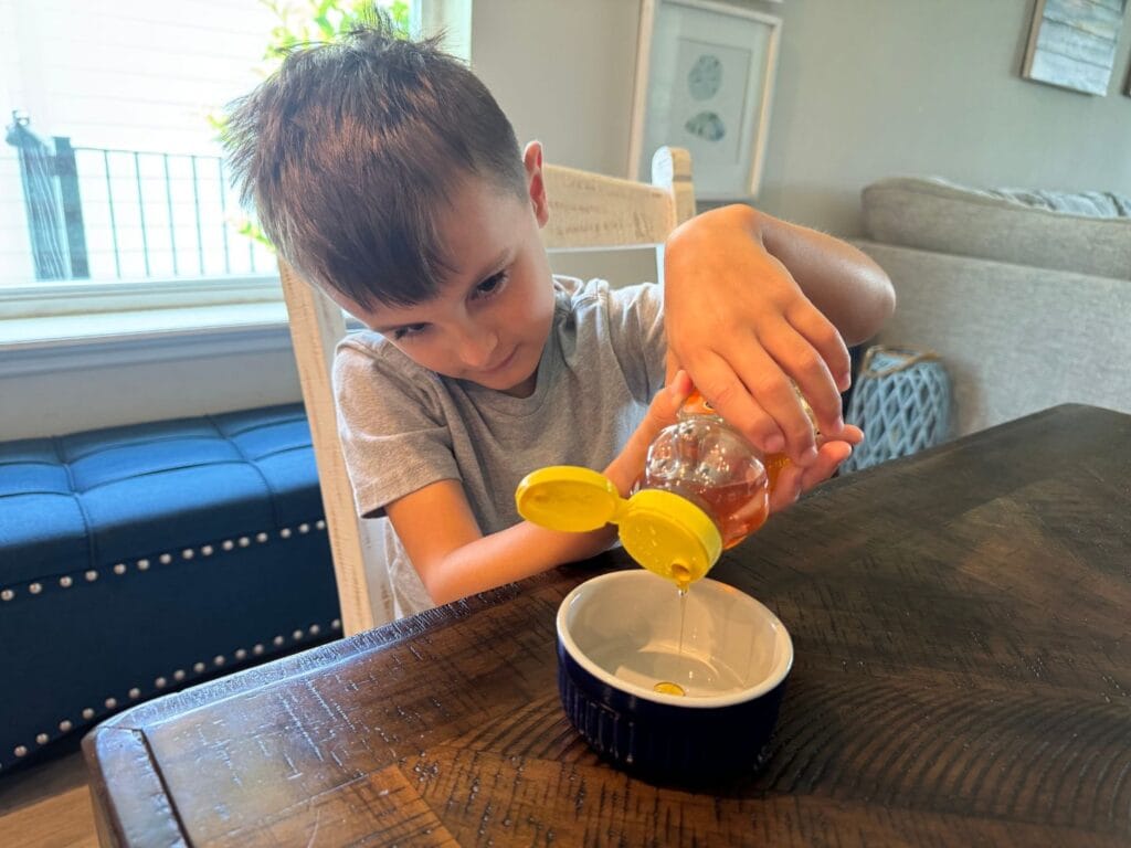 boy pouring honey