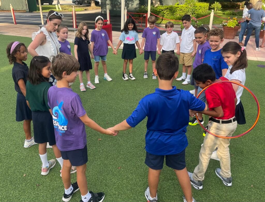 Students holding hands in a circle