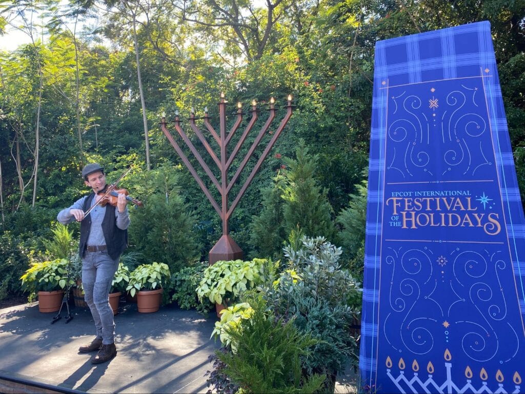 Hannukah Storyteller on stage at EPCOT Festival of the Holidays - image by Dani Meyering