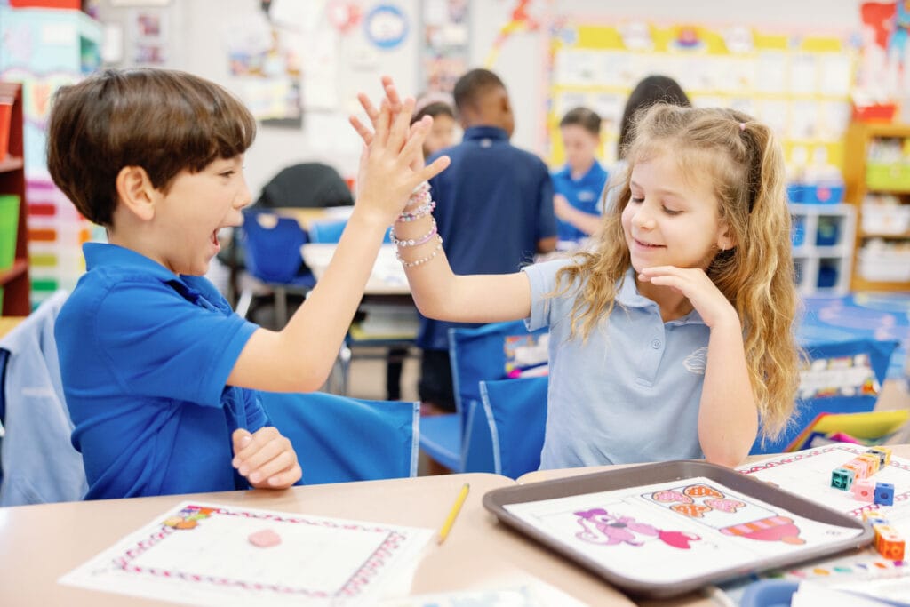 The First Academy students playing a hand game