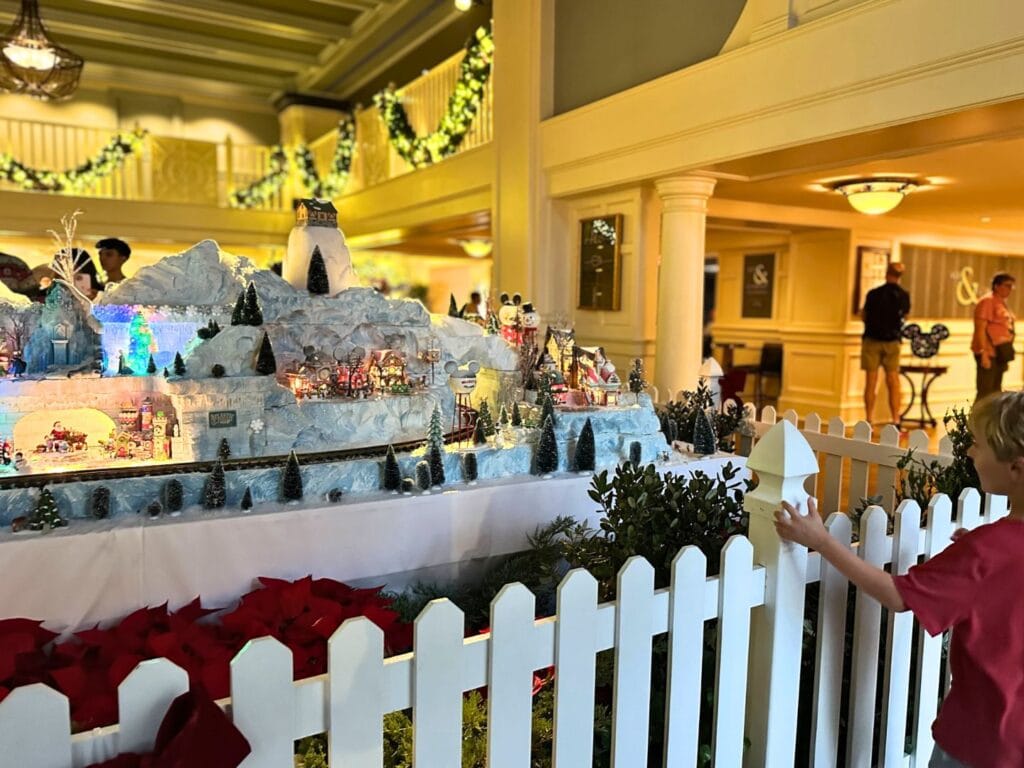 young boy looKs at Christmas Village at Yacht Club - image by Dani Meyering