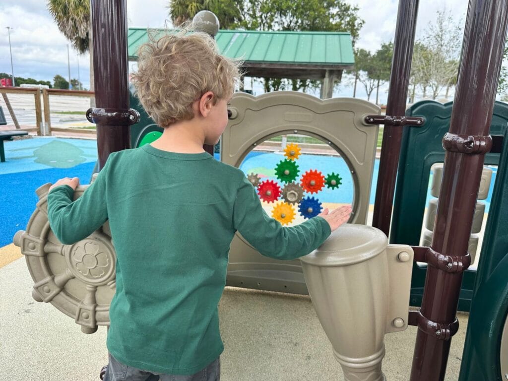 young boy plays at small playground Everglades Rest Area - image by Dani Meyering