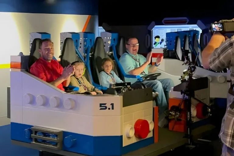 party of four in Galacticoaster ride vehicle at exit - image by Dani Meyering feature
