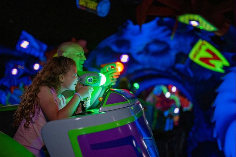 father and daughter ride Buzz Lightyears Space Ranger Spin