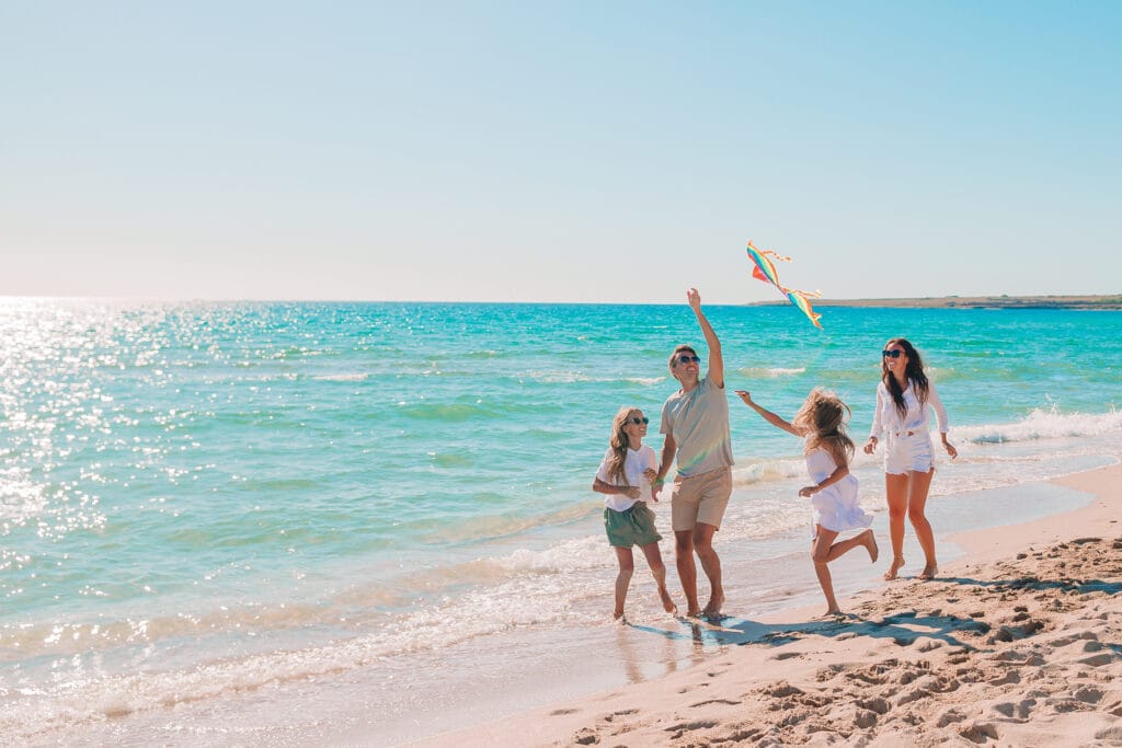 Family playing on a Caribbean beach AdobeStock_368111094