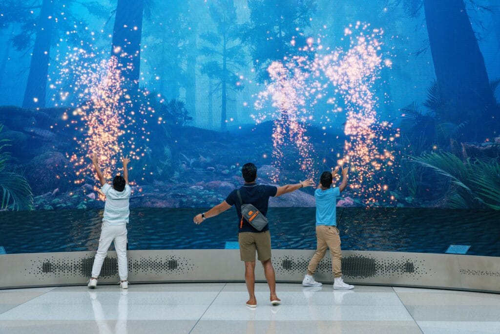 Family interacting with LED Screens at MCO Airport 