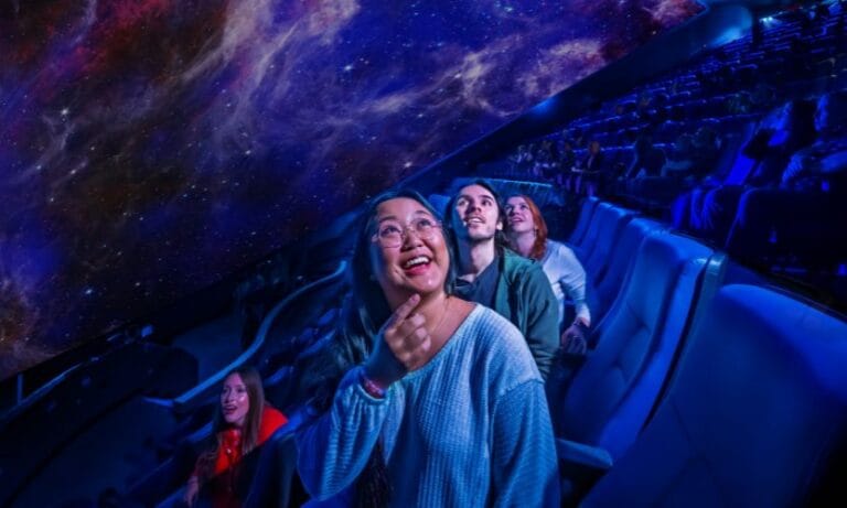 Young adults inside the new Orlando Science Center planetarium