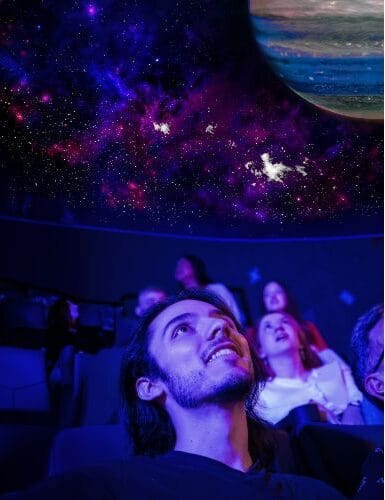 A gentleman stargazing inside the new Orlando Science Center dome