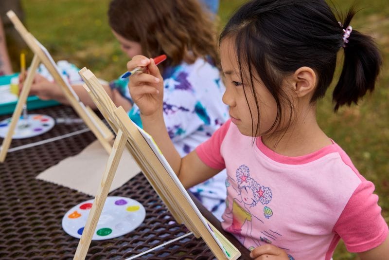 Champions Summer Camper painting outside