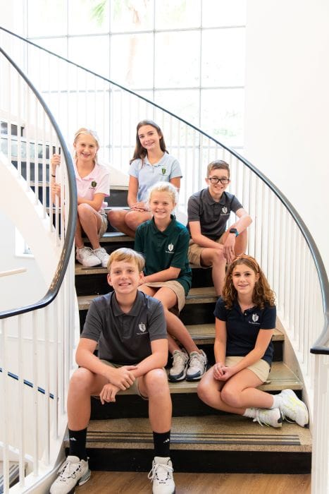 students at The Christ School sitting on a staircase