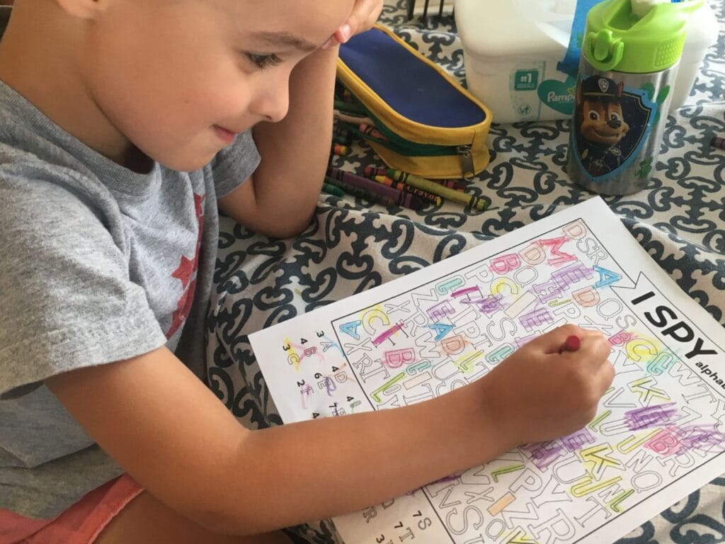 smiling boy coloring 