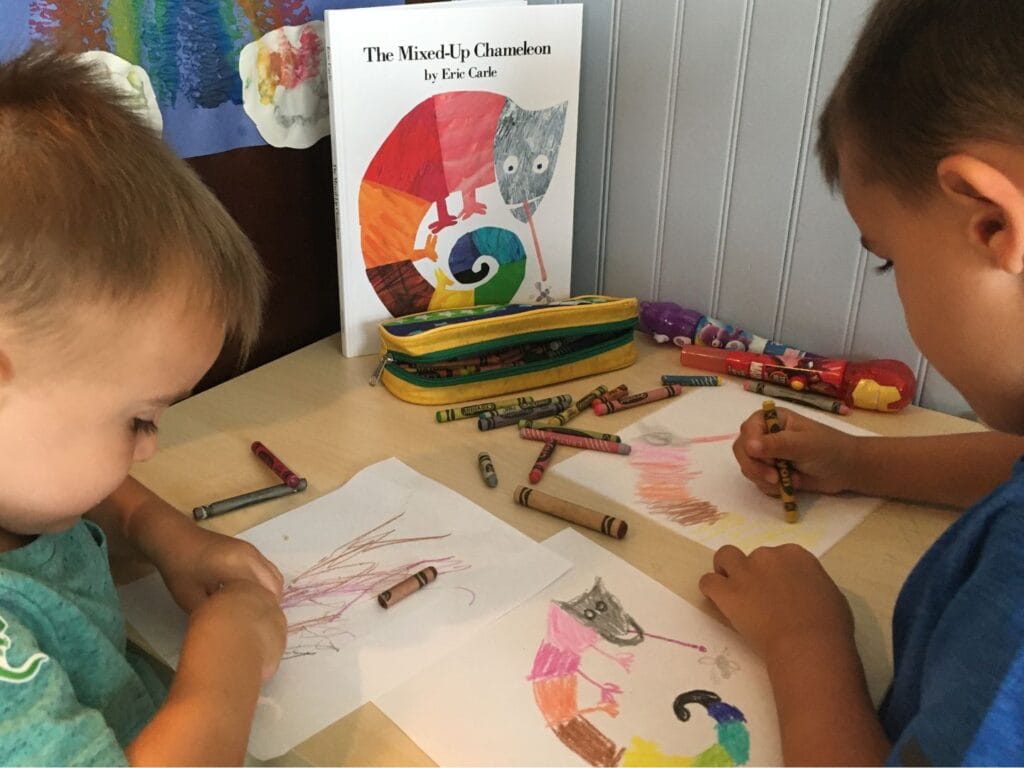 Two boys coloring with crayons. Used crayons can be donated.