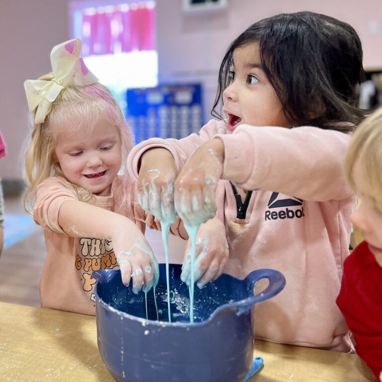 The Nest School Winter Garden photo two students playing with slime