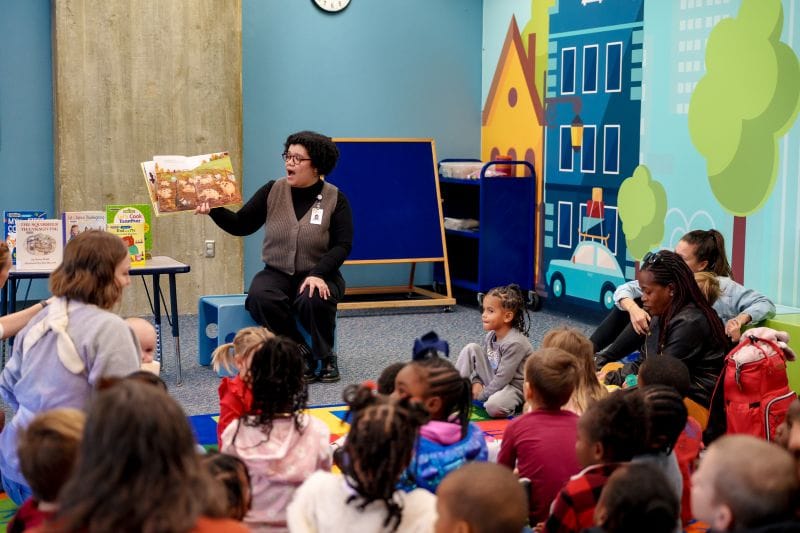Librarian reading to children and parents during a story time
