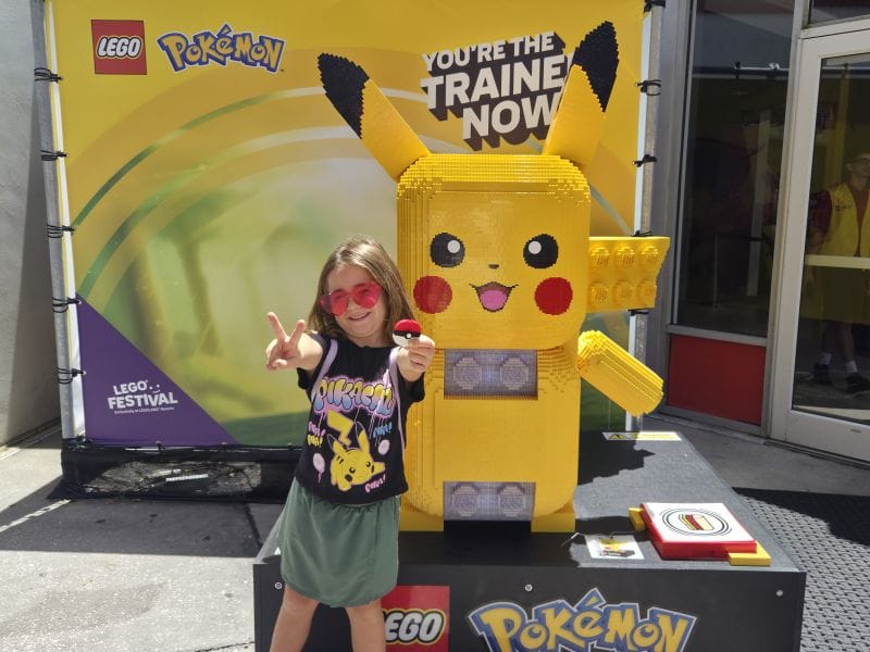 Girl posing with her poke ball and a giant LEGO Pikachu at LEGOLAND's LEGO Festival