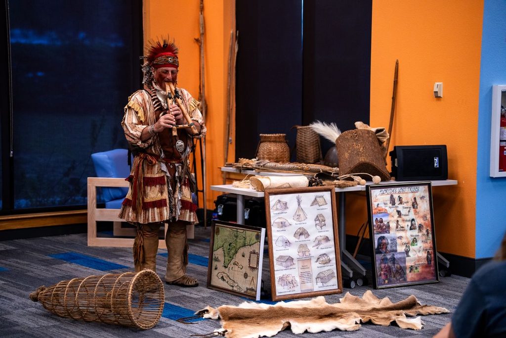 Native American educator Jim Sawgrass plays a flute at Orange County Library