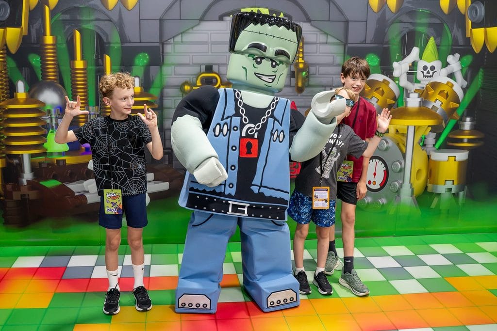 Three young boys posing with LEGO Frankenstein at Brick or Treat at LEGOLAND Florida Resort