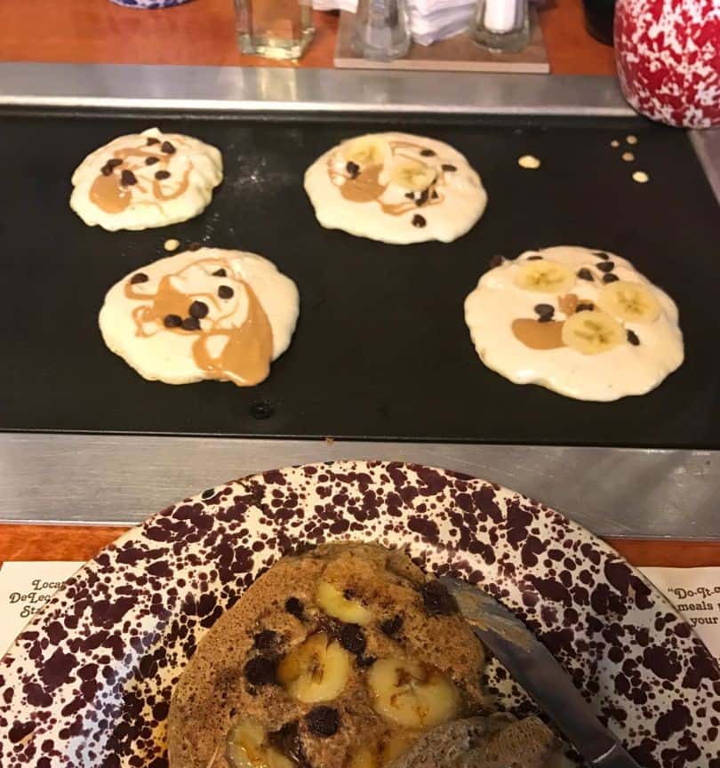 Pancakes with Toppings on Griddle and Plate at Old Sugar Mill Pancake House - image by Dani Meyering