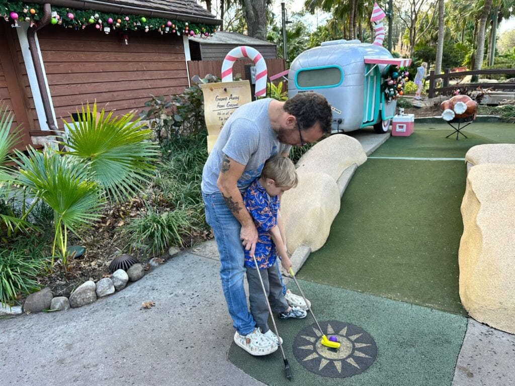 young boy plays at Winter Summerland Mini Golf summer course - image by Dani Meyering comp