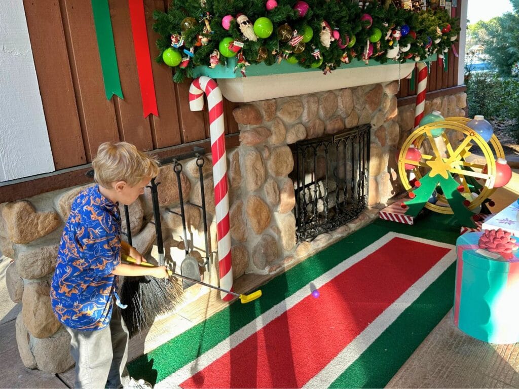 young boy plays at Winter Summerland Mini Golf winter course - image by Dani Meyering comp